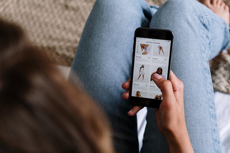 Person using smartphone for online shopping with cashback savings