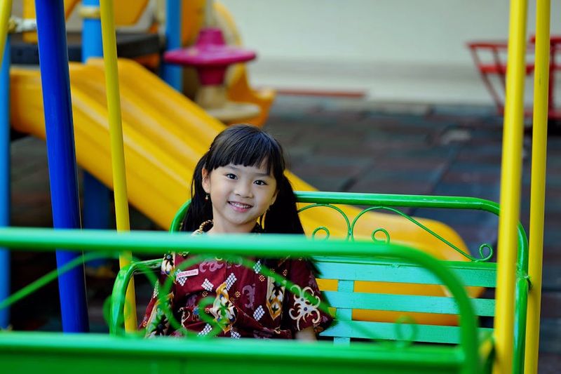 Kids playing together at a summer playground