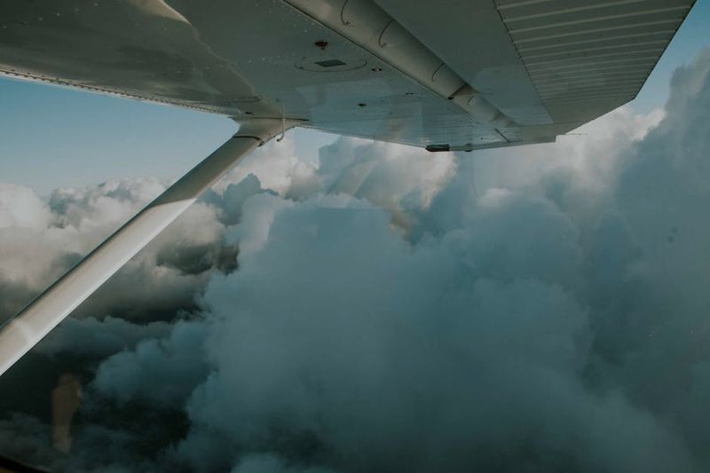 Airplane wing view above the clouds