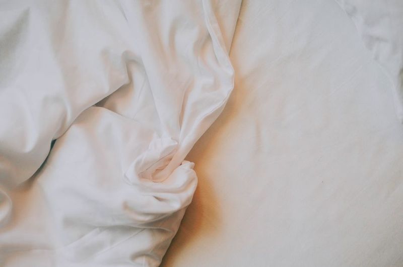 Cool bedroom setup with fan and cotton bedding for hot summer nights