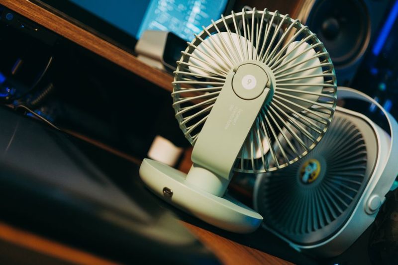 DIY cooling setup with fan and frozen bottles