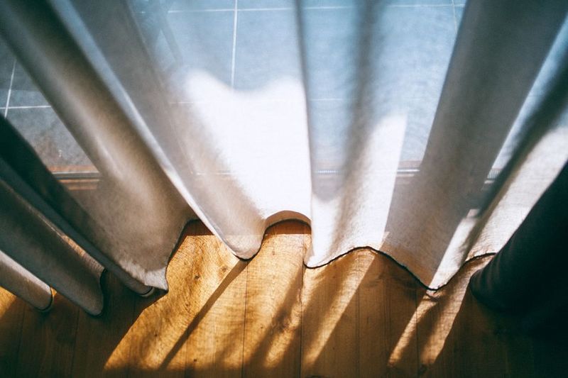 Windows with curtains drawn to block out summer heat