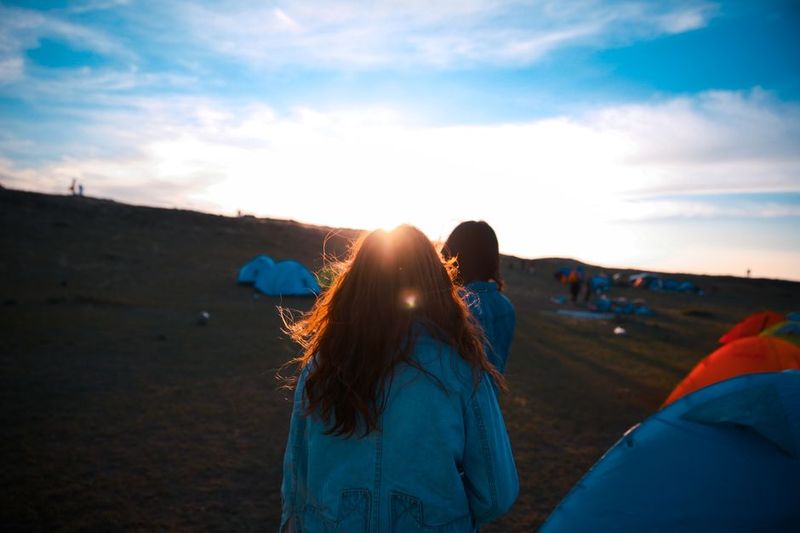Festival campsite with rows of tents at sunset