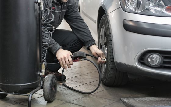 Car tyre being checked during MOT inspection