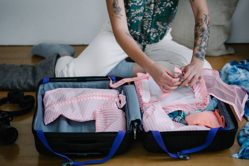 Packed suitcase with holiday essentials organised neatly